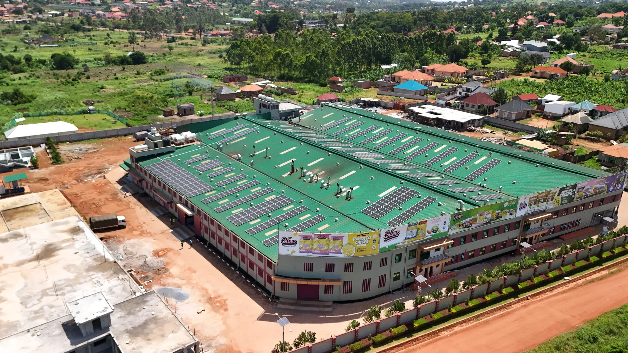 Aerial view of a rooftop solar installation on the factory roof at Sumz Food Industries in Uganda